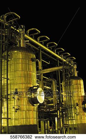 Stock Image - Low angle view of fuel storage tanks. Fotosearch