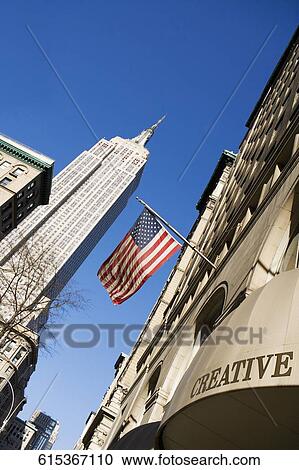 Stock Image - Low angle view of skyscrapers in a city, Empire State Building, Manhattan, New York City, New York State, USA. Fotosearch