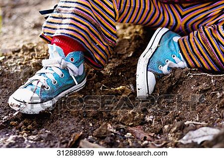 Low section view of a child sitting in dirt View Large Photo Image Stock Photo - Low section view of a child sitting in dirt. Fotosearch
