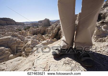Low section view of a hiker standing on a rock View Large Photo Image Stock Image - Low section view of a hiker standing on a rock. Fotosearch