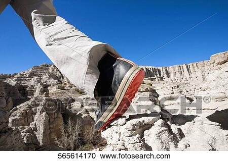Low section view of a hiker walking on a rock View Large Photo Image Stock Image - Low section view of a hiker walking on a rock. Fotosearch