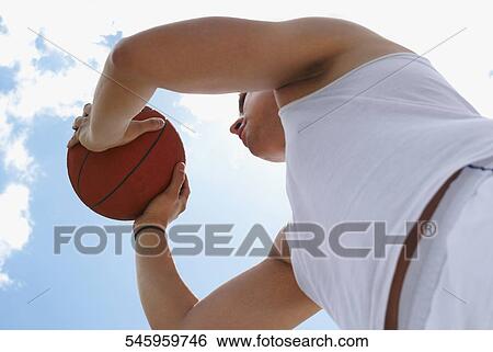 Low section view of a man playing basketball View Large Photo Image Stock Photograph - Low section view of a man playing basketball. Fotosearch
