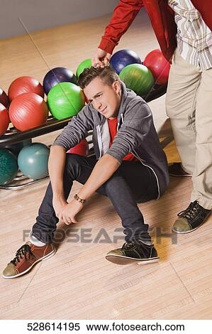 Low section view of a man punching on a young man's head View Large Photo Image Stock Photography - Low section view of a man punching on a young man's head. Fotosearch