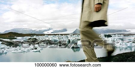 Low section view of a man walking near a glacier, Iceland View Large Photo Image Stock Image - Low section view of a man walking near a glacier, Iceland. Fotosearch