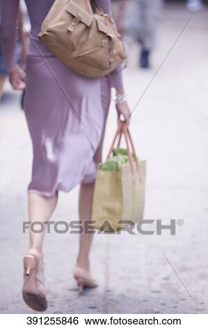 Low section view of a woman walking with a shopping bag, New York City, New York State, USA View Large Photo Image Stock Photograph - Low section view of a woman walking with a shopping bag, New York City, New York State, USA. Fotosearch
