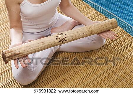 Low section view of a young woman meditating at the poolside View Large Photo Image Stock Image - Low section view of a young woman meditating at the poolside. Fotosearch
