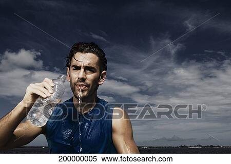 Male athlete drinking water View Large Photo Image Stock Photography - Male athlete drinking water. Fotosearch
