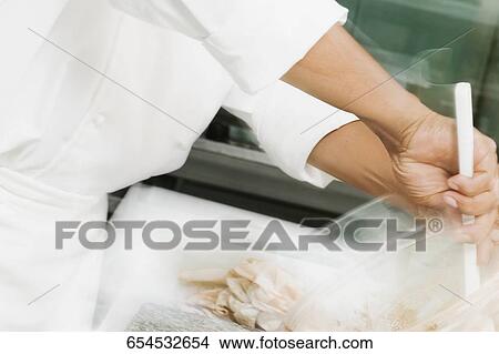 Male chef preparing food View Large Photo Image Picture - Male chef preparing food. Fotosearch