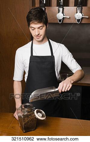 Male coffee shop owner putting coffee beans into a jar View Large Photo Image Stock Image - Male coffee shop owner putting coffee beans into a jar. Fotosearch
