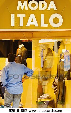 Man looking at the window display at a clothing store, Genoa, Liguria, Italy View Large Photo Image Stock Image - Man looking at the window display at a clothing store, Genoa, Liguria, Italy. Fotosearch