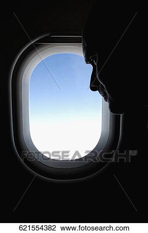 Stock Image - Man near a window in an airplane. Fotosearch