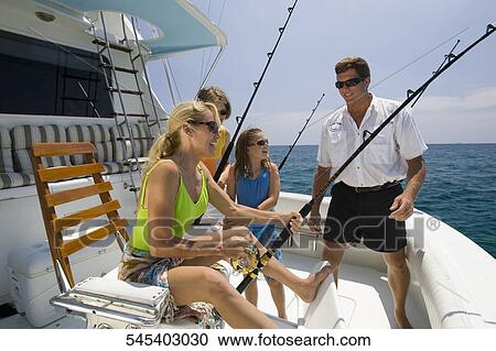 Mature couple fishing with their children View Large Photo Image Stock Image - Mature couple fishing with their children. Fotosearch
