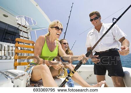 Mature couple fishing with their daughter View Large Photo Image Stock Photography - Mature couple fishing with their daughter. Fotosearch