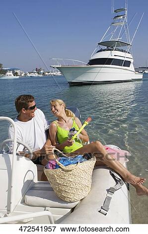 Stock Photo - Mature couple on an inflatable raft. Fotosearch