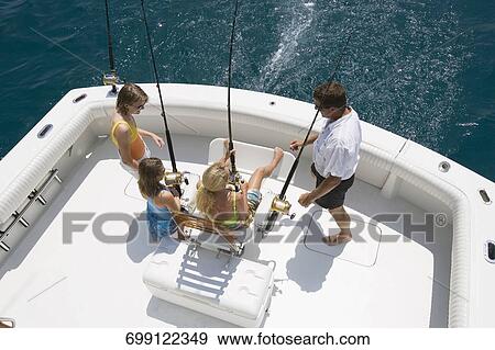 Mature couple with their children fishing in the sea View Large Photo Image Stock Photo - Mature couple with their children fishing in the sea. Fotosearch