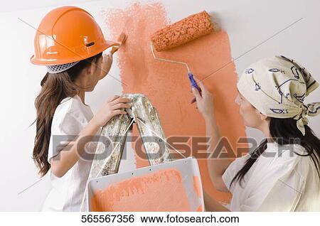 Mature woman and her daughter painting the wall View Large Photo Image Stock Photograph - Mature woman and her daughter painting the wall. Fotosearch