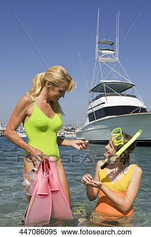 Mature woman with her daughter holding flippers and smiling View Large Photo Image Stock Photography - Mature woman with her daughter holding flippers and smiling. Fotosearch