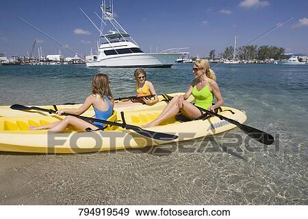 Mature woman with her daughters sitting in a kayak View Large Photo Image Stock Photo - Mature woman with her daughters sitting in a kayak. Fotosearch