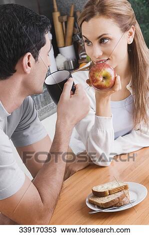 Mid adult couple having breakfast View Large Photo Image Stock Image - Mid adult couple having breakfast. Fotosearch