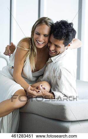 Mid adult couple romancing and smiling View Large Photo Image Stock Image - Mid adult couple romancing and smiling. Fotosearch