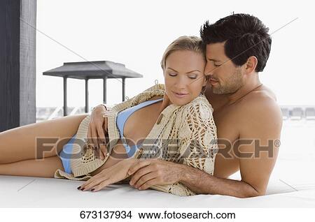 Mid adult couple romancing at the poolside View Large Photo Image Picture - Mid adult couple romancing at the poolside. Fotosearch