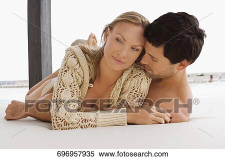 Mid adult couple romancing at the poolside View Large Photo Image Stock Photography - Mid adult couple romancing at the poolside. Fotosearch