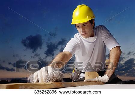 Mid adult man carpentry View Large Photo Image Stock Photograph - Mid adult man carpentry. Fotosearch