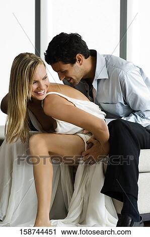 Mid adult man embracing a mid adult woman from behind View Large Photo Image Stock Image - Mid adult man embracing a mid adult woman from behind. Fotosearch