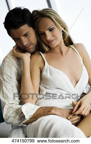 Mid adult man embracing a mid adult woman from behind View Large Photo Image Stock Photo - Mid adult man embracing a mid adult woman from behind. Fotosearch