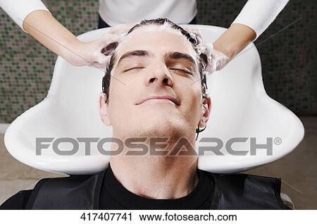 Mid adult man getting hair shampooed at salon View Large Photo Image Stock Image - Mid adult man getting hair shampooed at salon. Fotosearch