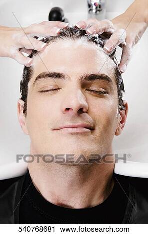 Mid adult man getting hair shampooed at salon View Large Photo Image Stock Image - Mid adult man getting hair shampooed at salon. Fotosearch