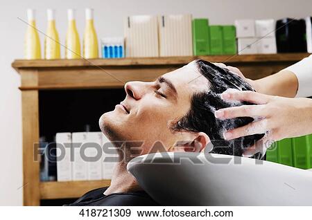 Mid adult man getting hair shampooed at salon View Large Photo Image Stock Photo - Mid adult man getting hair shampooed at salon. Fotosearch