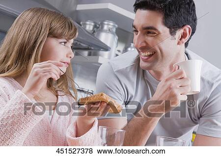 Mid adult man having breakfast with his daughter and smiling View Large Photo Image Stock Photo - Mid adult man having breakfast with his daughter and smiling. Fotosearch