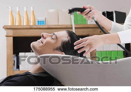 Mid adult man having hair washed in hair salon View Large Photo Image Stock Photography - Mid adult man having hair washed in hair salon . Fotosearch