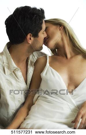 Mid adult man kissing a mid adult woman View Large Photo Image Stock Image - Mid adult man kissing a mid adult woman. Fotosearch