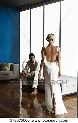 Mid adult man looking at a mid adult woman View Large Photo Image Stock Photograph - Mid adult man looking at a mid adult woman. Fotosearch