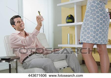 Mid adult man photographing of a woman with a digital camera View Large Photo Image Stock Photograph - Mid adult man photographing of a woman with a digital camera. Fotosearch