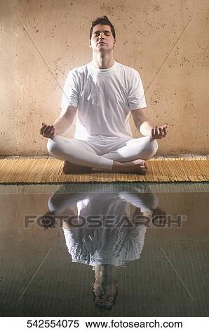 Mid adult man practicing yoga at the poolside View Large Photo Image Stock Photography - Mid adult man practicing yoga at the poolside. Fotosearch