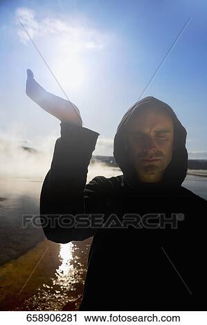 Mid adult man practicing yoga near a hot spring, Grand Prismatic Spring, Yellowstone National Park, Wyoming, USA View Large Photo Image Stock Image - Mid adult man practicing yoga near a hot spring, Grand Prismatic Spring, Yellowstone National Park, Wyoming, USA. Fotosearch