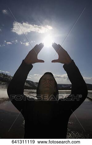 Mid adult man practicing yoga near a hot spring, Grand Prismatic Spring, Yellowstone National Park, Wyoming, USA View Large Photo Image Stock Photo - Mid adult man practicing yoga near a hot spring, Grand Prismatic Spring, Yellowstone National Park, Wyoming, USA. Fotosearch