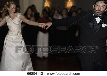 Stock Image - Mid adult woman dancing with a mature man. Fotosearch