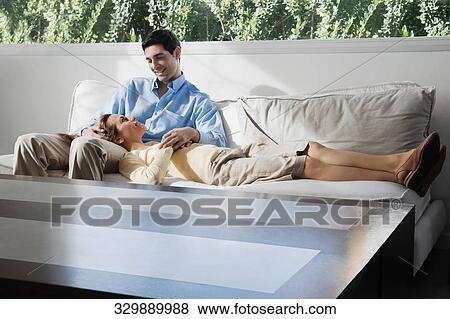 Mid adult woman lying on a mid adult man's lap and smiling View Large Photo Image Stock Photo - Mid adult woman lying on a mid adult man's lap and smiling. Fotosearch