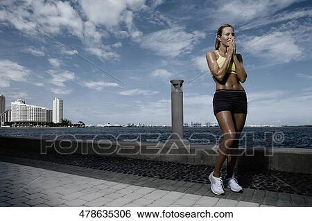 Mid adult woman standing at the riverside View Large Photo Image Stock Photograph - Mid adult woman standing at the riverside. Fotosearch