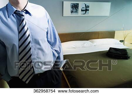 Mid section view of a businessman standing with his hands in his pockets View Large Photo Image Picture - Mid section view of a businessman standing with his hands in his pockets. Fotosearch