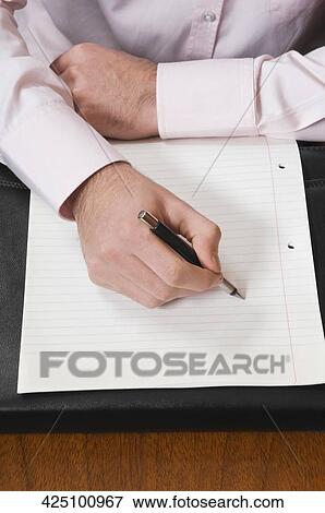 Mid section view of a businessman writing on a sheet of paper with a pen View Large Photo Image Stock Photo - Mid section view of a businessman writing on a sheet of paper with a pen. Fotosearch