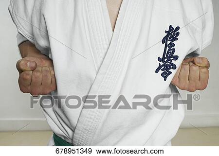 Stock Photo - Mid section view of a man practicing karate. Fotosearch