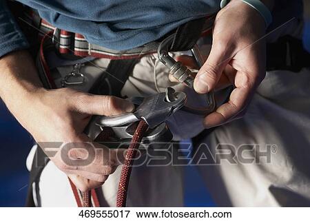 Mid section view of a man preparing for rock climbing View Large Photo Image Stock Photo - Mid section view of a man preparing for rock climbing. Fotosearch
