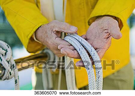 Mid section view of a senior man's hand holding ropes View Large Photo Image Stock Image - Mid section view of a senior man's hand holding ropes. Fotosearch