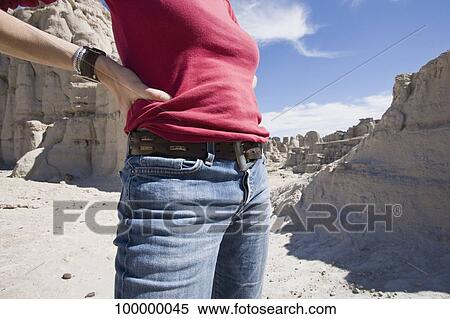 Mid section view of a woman standing with arms akimbo View Large Photo Image Stock Photography - Mid section view of a woman standing with arms akimbo. Fotosearch