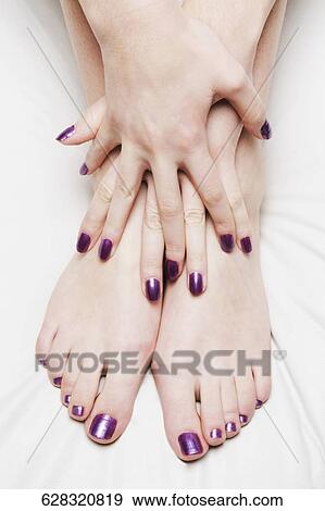 Nail polish on the legs and hands of a woman View Large Photo Image Stock Photo - Nail polish on the legs and hands of a woman. Fotosearch